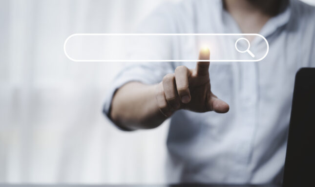 Hand touching with search icon for Search Engine Optimisation or SEO concept to find information by internet connection.