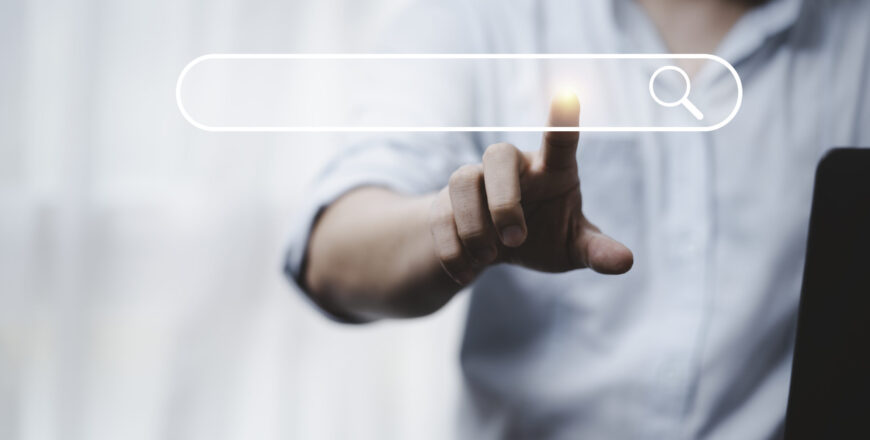 Hand touching with search icon for Search Engine Optimisation or Hand touching with search icon for Search Engine Optimisation or SEO concept to find information by internet connection.