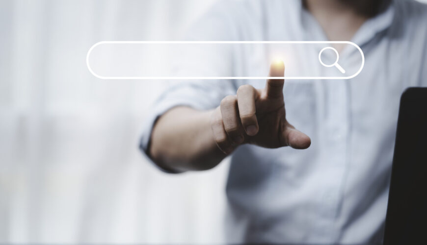 Hand touching with search icon for Search Engine Optimisation or SEO concept to find information by internet connection.